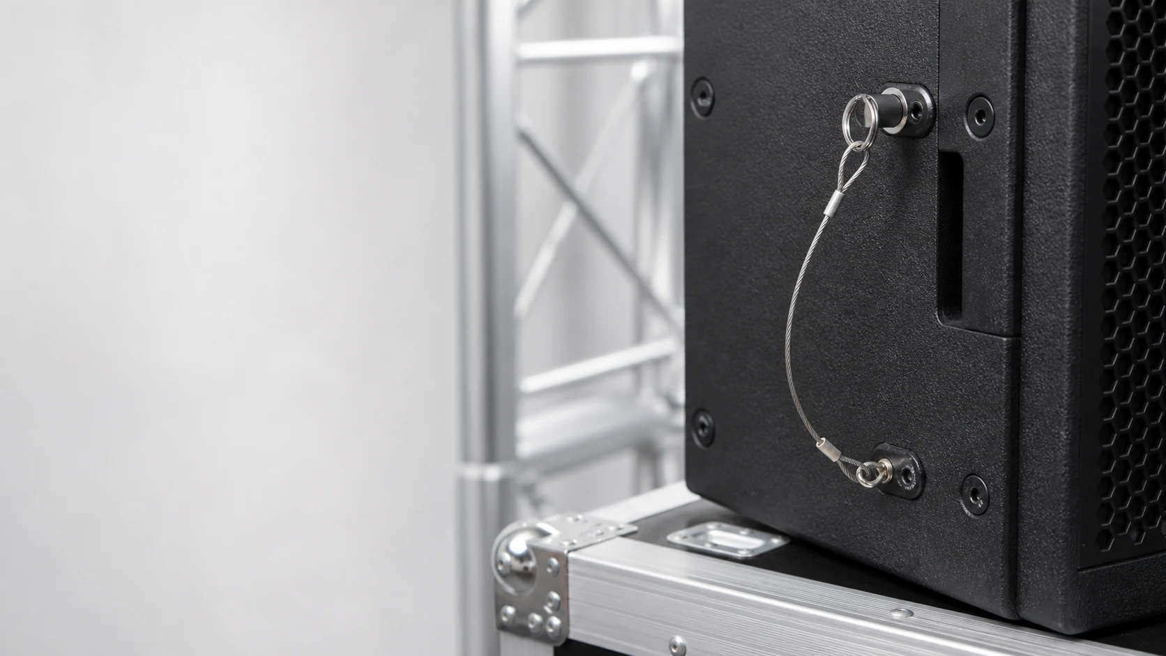 Safety tether cable attached to a professional audio speaker cabinet